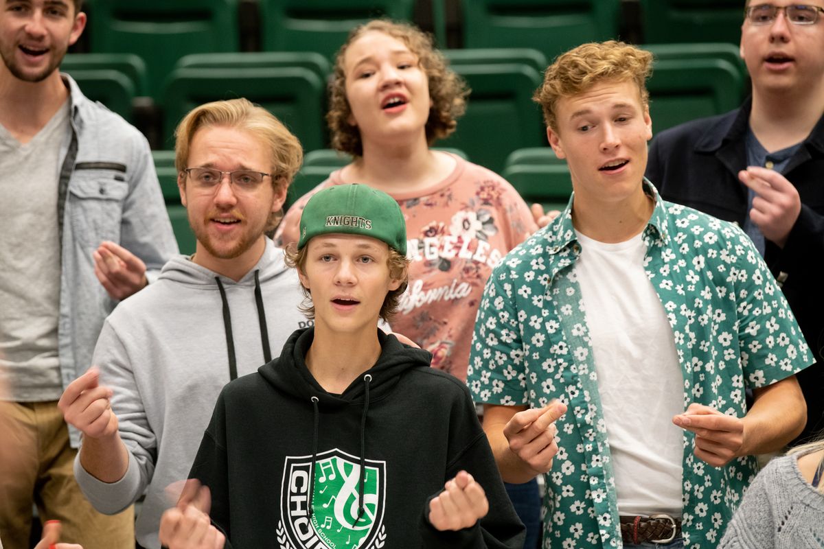 Members of the East Valley High School choir, including Dean Roberson, with glasses, Kasen Buck, in hat, and Casey Noack, in floral shirt, add finger snaps as they rehearse the choral part of the Foreigner hit song “I Want to Know What Love Is” on Sept. 9, 2019. The choir will sing with Foreigner again this month at Northern Quest Resort & Casino. (Jesse Tinsley/The Spokesman-Review)