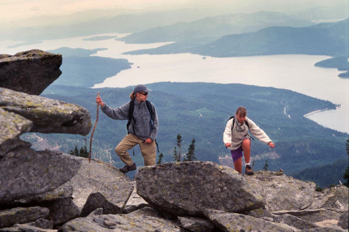 Hikers scramble on granite boulders near the summit of Lookout Mountain above Priest Lake. (Rich Landers / The Spokesman-Review)