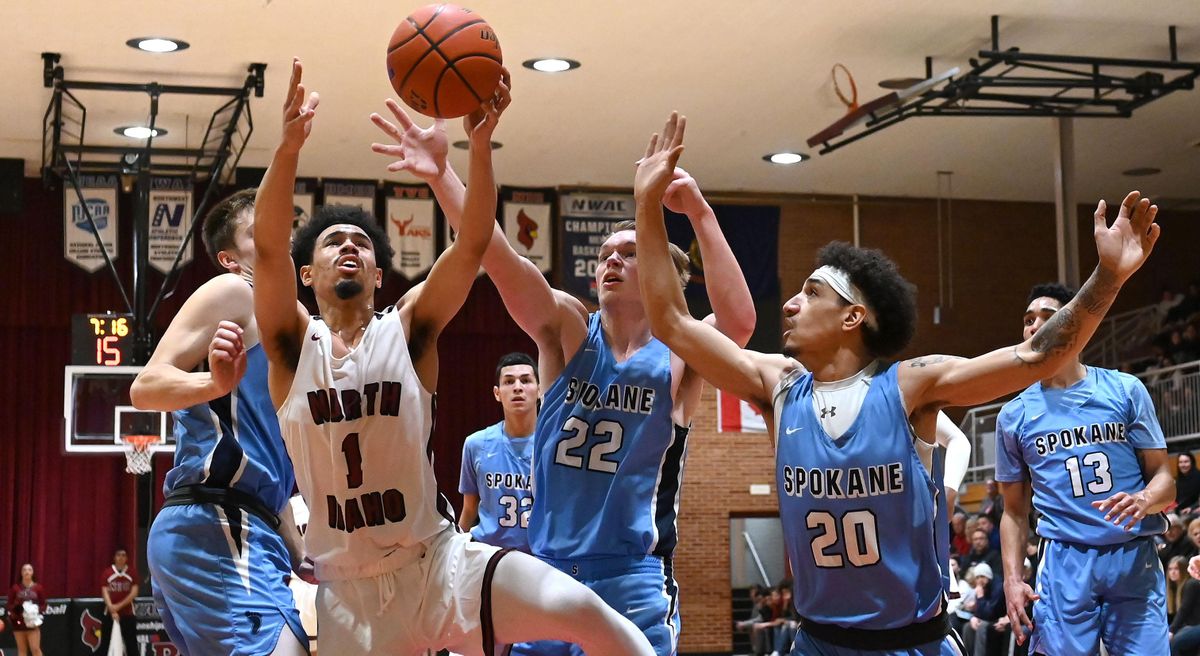North Idaho point guard Nate Pryor (1) competes for a rebound with Community Colleges of Spokane guard Garrett White (22) during a college basketball game, Wed. Feb. 20, 2019, at NIC. (Colin Mulvany / The Spokesman-Review)