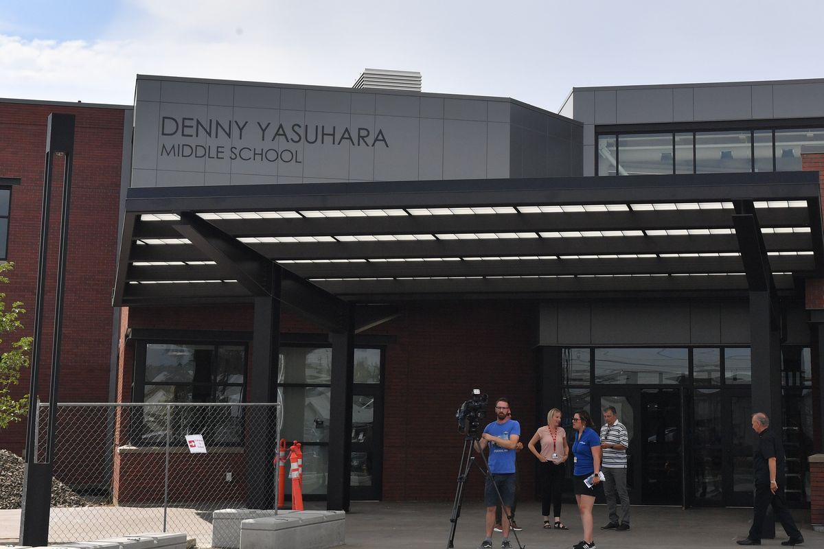 Media members gather outside Denny Yasuhara Middle School before a tour on Wednesday, Aug. 24, 2022, in Spokane, Wash.  (Tyler Tjomsland/The Spokesman-Review)