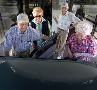 
Bruno Costa opens a door on his car to take a load of friends and neighbors from Cathedral Plaza to the grocery store on Thursday. 
 (Christopher Anderson/ / The Spokesman-Review)