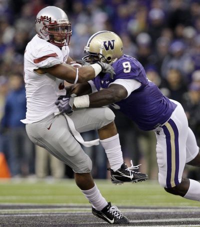 Donald Butler, right, helped Washington beat Dwight Tardy and Washington State during the 2009 Apple Cup.  (Associated Press)