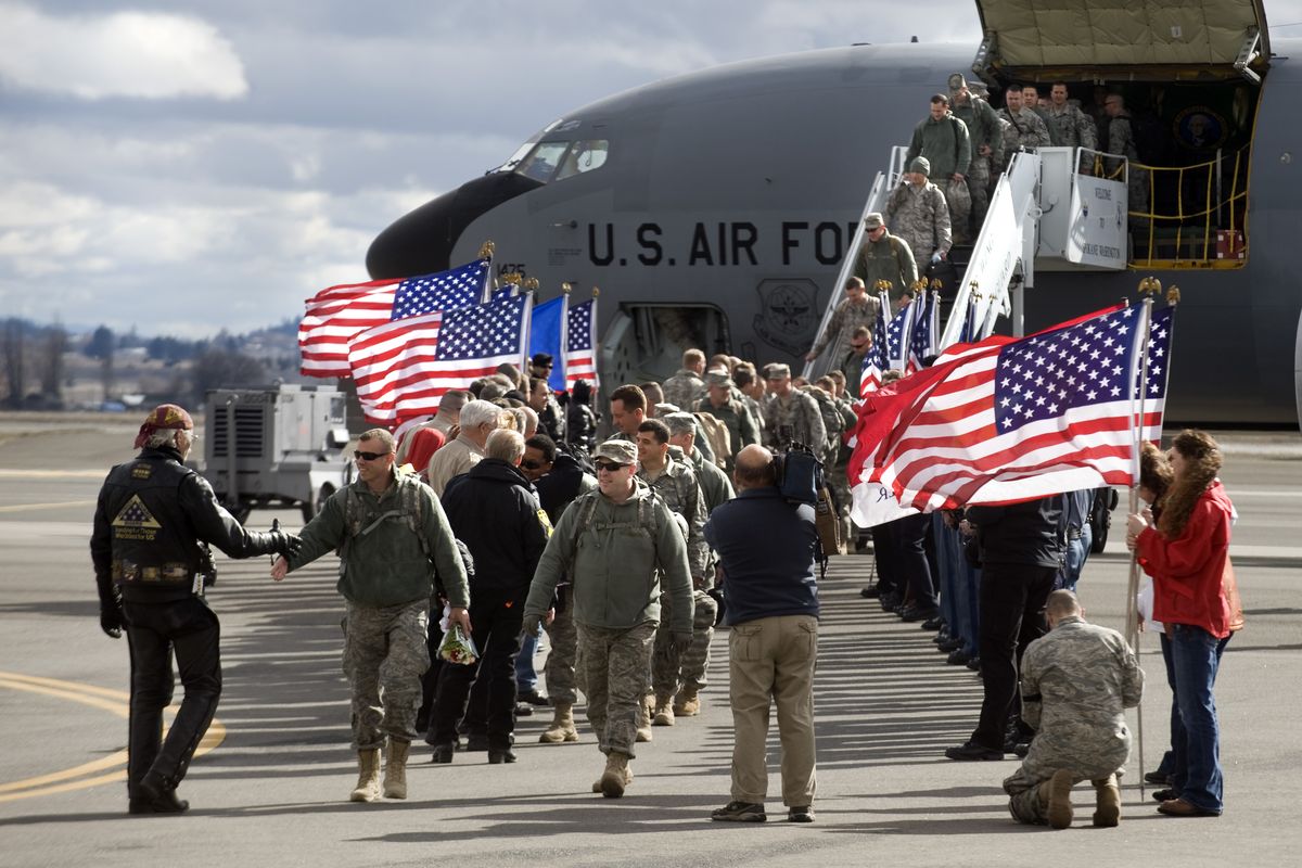 The Patriot Guard greets about 40 members of the Air National Guard 141st ARW Security Forces as they arrive at Fairchild Air Force Base after a six-month tour in Iraq on Thursday, Feb. 25, 2010. (Colin Mulvany / The Spokesman-Review)