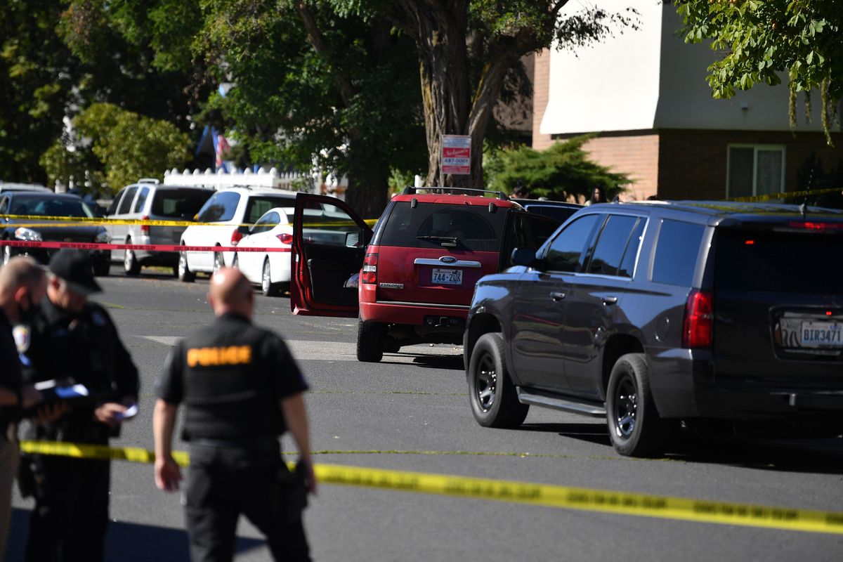 Officers belonging to a U.S. Marshals Service task force shot and wounded a man in Spokane’s Hillyard Neighborhood on Monday after he was allegedly involved in a shooting the night before.  (Tyler Tjomsland / The Spokesman-Review)