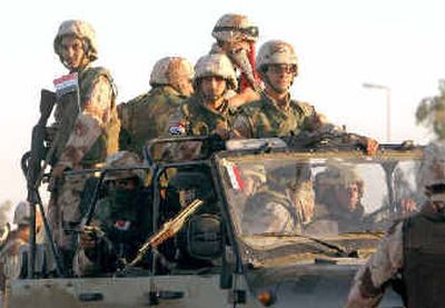 
Iraqi National Guard soldiers head out on an evening patrol from Camp Victory near Baghdad, Iraq, on Thursday. Iraqi National Guard soldiers head out on an evening patrol from Camp Victory near Baghdad, Iraq, on Thursday. 
 (Associated PressAssociated Press / The Spokesman-Review)