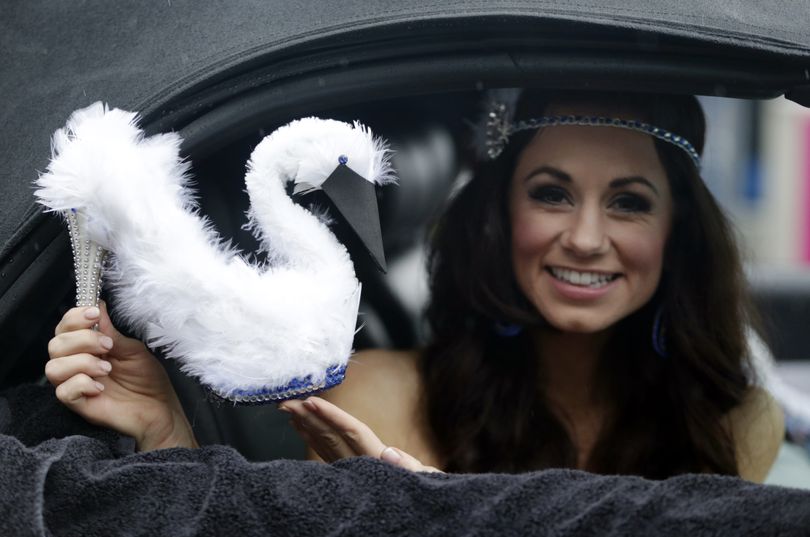 Baring her sole: Miss Montana Victoria Valentine displays her shoe during the Miss America Shoe Parade at the Atlantic City boardwalk on Saturday in Atlantic City, New Jersey. The traditional “Show Us Your Shoes” parade featured 53 Miss America hopefuls riding in convertibles, each sporting creatively decorated shoes to evoke their home state. Miss Oregon Rebecca Anderson had tiny bicycles on her shoes and wore a helmet since Portland is known as a bike-friendly city. The next Miss America will be crowned during tonight’s televised competition. (Associated Press)