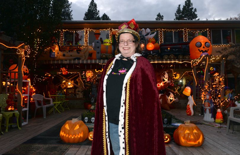 Chris Sheppard dons only one costume on Halloween, a robe, crown and sweatshirt reading “Queen of Halloween.” Indeed, her house dominates the neighborhood, with hundreds of whimsical items for the holiday. Sheppard is shown at her home, 1722 S. Bettman Road in Spokane Valley, on Wednesday. (Jesse Tinsley)