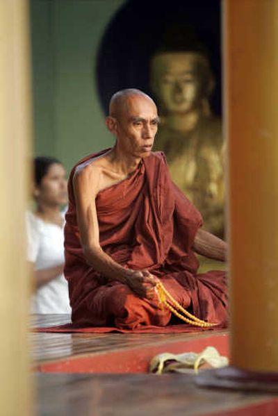
A Myanmar Buddhist monk prays in 2005 at Shwedagon temple in Yangon.Associated Press
 (Associated Press / The Spokesman-Review)