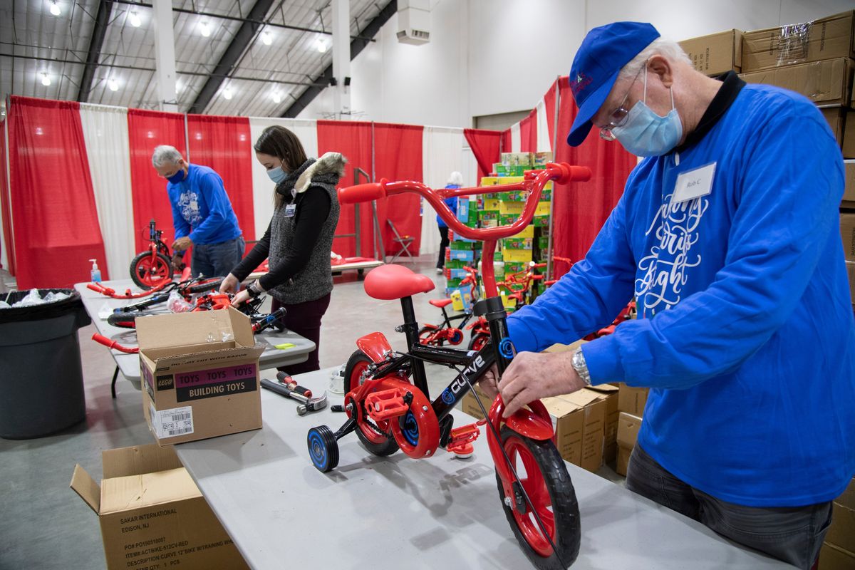 Volunteers, from left, Walt Erikson, Heather Sulpizio and Bob Curry assemble toddlers