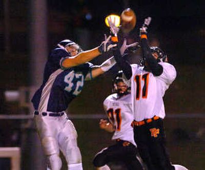 
Lake City's Christian Hanna, left, and Post Falls' Dakota Allert, right, vie for a pass in the end zone. Allert made the interception. 
 (Jesse Tinsley / The Spokesman-Review)