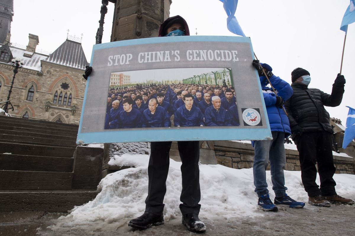 Protesters gather outside the Parliament buildings in Ottawa, Ontario, Monday, Feb. 22, 2021. Parliament is expected to vote on an opposition motion calling on Canada to recognize China