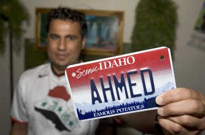 
Ahmed Al-Fahdi displays his personalized motorcycle license plate in his apartment May 24 in Boise.  Al-Fahdi, an Iraqi refugee, has sued the U.S. government over his long wait for an FBI name check, a required step for U.S. citizenship. His wife, still in Iraq, is expecting their first child in two months. Associated Press
 (Associated Press / The Spokesman-Review)