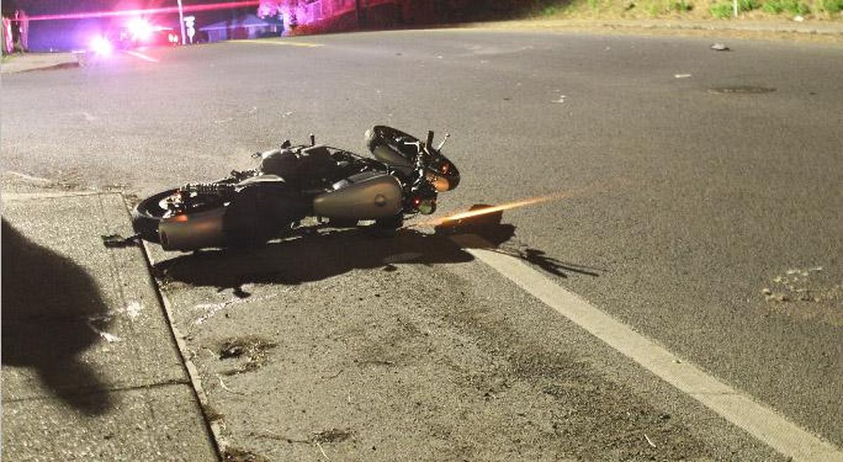 Daniel “Dutch” Inwood’s motorcycle lies in the street after the April 23 crash that severed his left leg. (Spokane Police Department)
