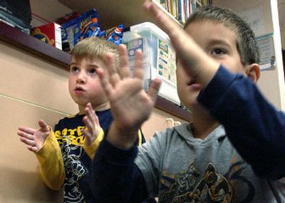 
Kindergarteners Josh Ifrid, 5, left, and Jacob Halverson, 5, sing and clap Thursday in class at Otis Orchards Elementary School. The East Valley School District is launching a new program that will help its future students enter school ready to learn. 
 (Joe Barrentine / The Spokesman-Review)