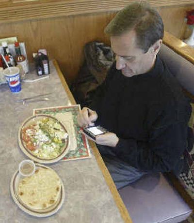 Mike Brezonic of Waukesha, Wis., enters nutritional data into his PDA.
(Associated Press / The Spokesman-Review)