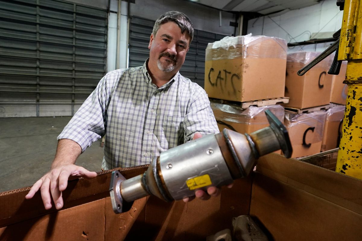 Troy Webber, owner of Chesterfield Auto Parts, holds a used catalytic converter that was removed from one of the cars at his salvage yard Friday Dec. 17, 2021, in Richmond, Va. Thefts of the emission control devices have jumped over the last two years as prices for the precious metals they contain have skyrocketed.  (Steve Helber)