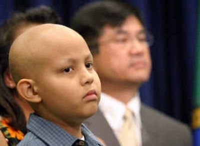 
Eleven-year-old Greg Hachey, of Puyallup, Wash., listens along with Gov. Gary Locke, right, during a news conference appealing for multi-ethnic bone marrow donors in Olympia on Thursday. Hachey, who has leukemia, is in need of a bone marrow transplant; however, a suitable match has not been found.
 (Associated Press / The Spokesman-Review)