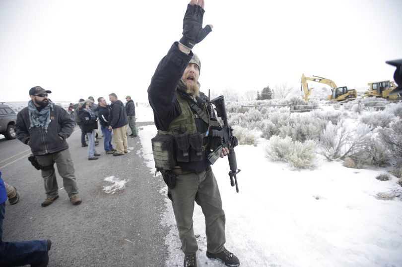 A man standing guard pushes the media aside after members of the 