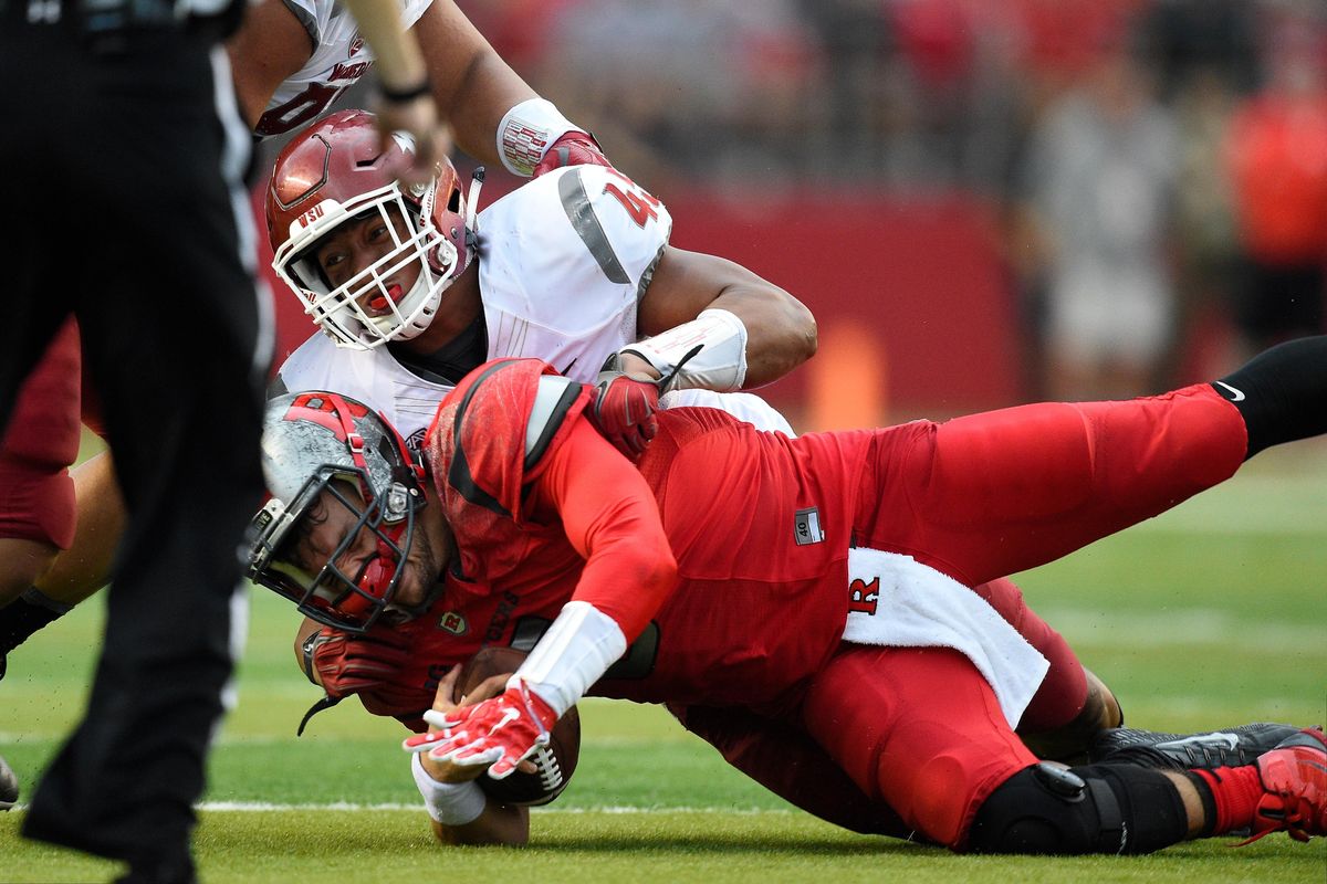 Rutgers quarterback Chris Laviano is greeted by Washington State linebacker Logan Tago during the Cougars 37-34 win last September. (Rich Kane / Associated Press)