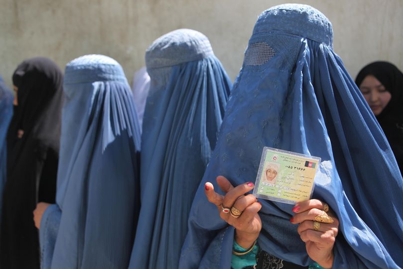 ORG XMIT: RMX120 Afghan women voters line up to cast their ballots at a polling station in Kabul Thursday Aug. 20, 2009. Afghans voted under the shadow of Taliban threats of violence Thursday to choose their next president for a nation plagued by armed insurgency, drugs, corruption and a feeble government nearly eight years after the U.S.-led invasion. (AP Photo/Rafiq Maqbool) (Rafiq Maqbool / The Spokesman-Review)