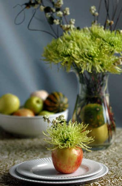 
Spider mums and snowberries displayed in an apple make a lovely centerpiece for an autumn table.
 (INGRID BARRENTINE/ / The Spokesman-Review)