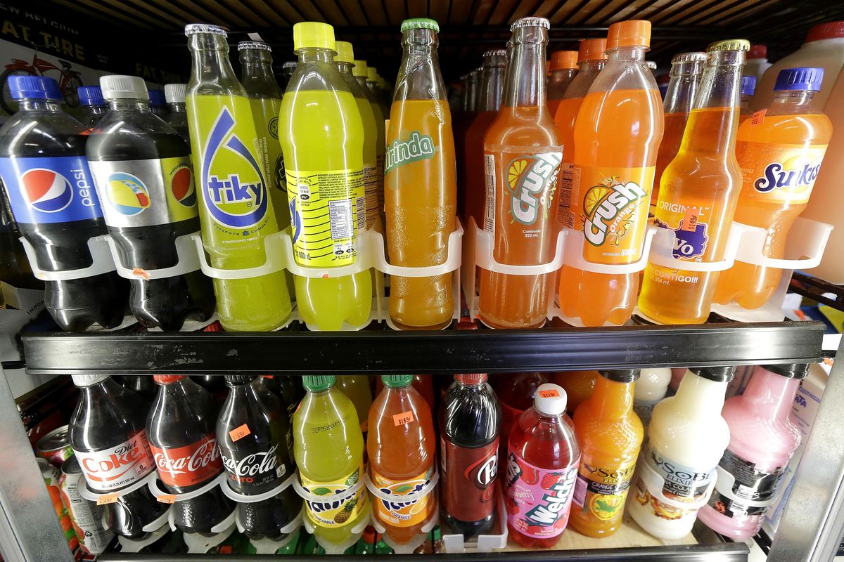 This Sept. 21, 2016 file photo shows soft drink and soda bottles displayed in a refrigerator at El Ahorro market in San Francisco. Washington voters can expect to see legislation proposed this November that prevents new taxation on soft drinks. (Jeff Chiu / AP)