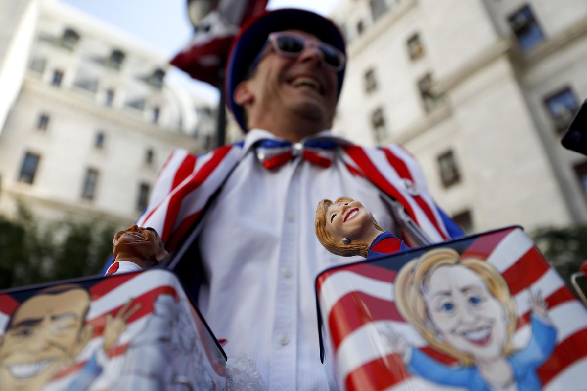 A toy vendor sells a Democratic presidential candidate Hillary Clinton jack-in-the-box near City Hall in Philadelphia, Tuesday, July 26, 2016, during the second day of the Democratic National Convention. (John Minchillo / Associated Press)