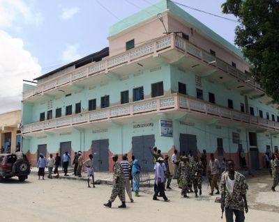 Somali government forces patrol outside the Muna Hotel in Mogadishu, Somalia, on Tuesday. (Associated Press)