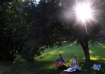Vlad Golovin and Julia Hunton, 16, both of Rosalia, sing songs in Cannon Hill Park Tuesday afternoon as their family spent the day in Spokane. 
 (Rajah Bose / The Spokesman-Review)