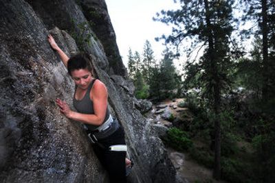 
Sara Kellard scales the side of Minnehaha rocks in Shields Park, across from Upriver Dam, last Thursday. 
 (Photos by RAJAH BOSE / The Spokesman-Review)