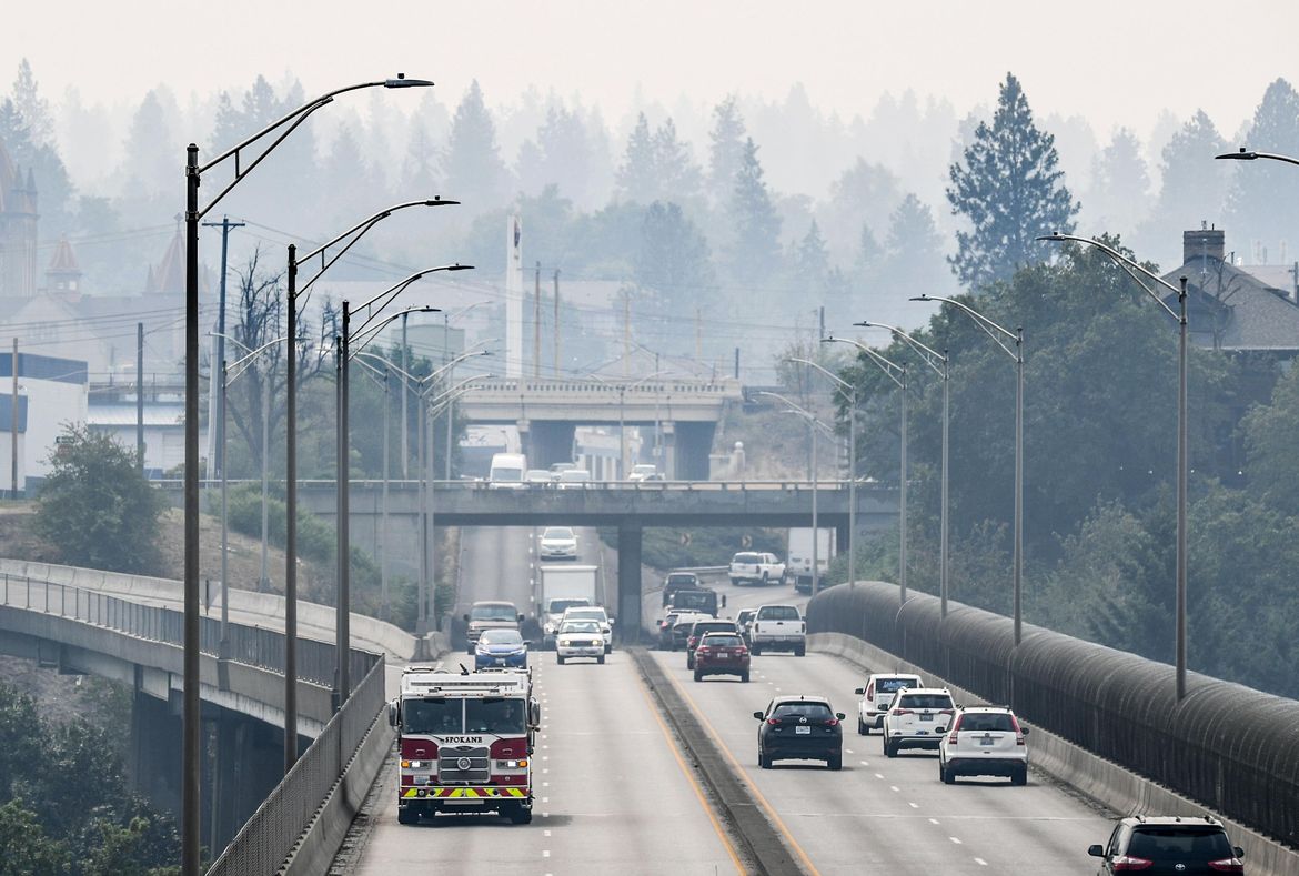 Wildfire smoke shrouds the South Hill as a Spokane Fire Department engine rolls across the Maple Street Bridge