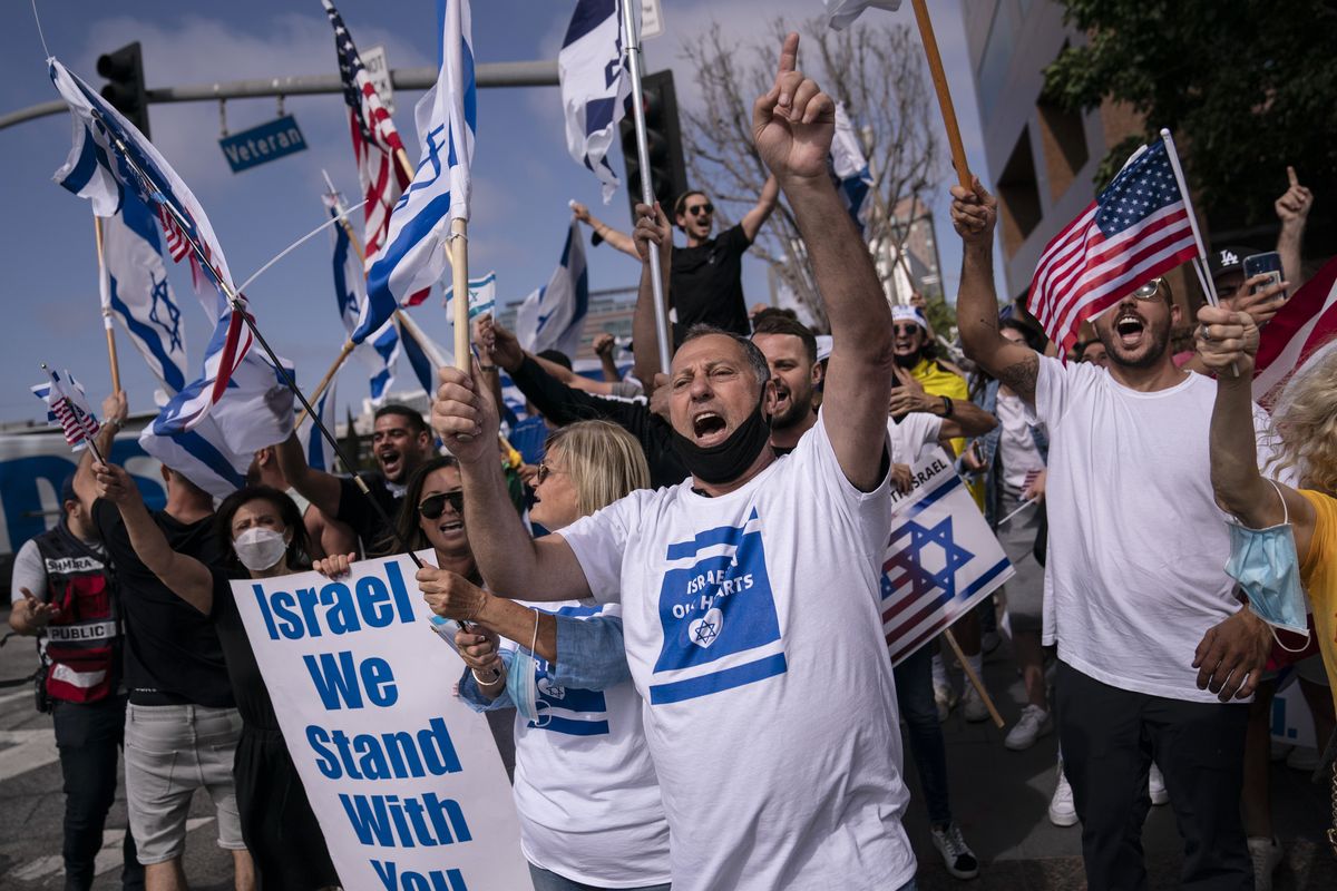 FILE - Pro-Israel supporters chant slogans during a rally in support of Israel outside the Federal Building in Los Angeles, Wednesday, May 12, 2021. A larger debate is playing out nationwide among many U.S. Jews who are divided over how to respond to the violence and over the disputed boundaries for acceptable criticism of Israeli policies.  (Jae C. Hong)