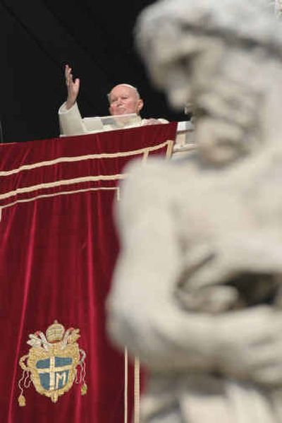 
Pope John Paul II gives his blessing Wednesday as he appears at the window of his studio overlooking St. Peter's Square at the Vatican.
 (Associated Press / The Spokesman-Review)