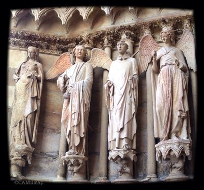 Stone figures, including the historic Smiling Angel of Reims, guard the cathedral in Reims, France. (Cheryl-Anne Millsap / Photo by Cheryl-Anne Millsap)