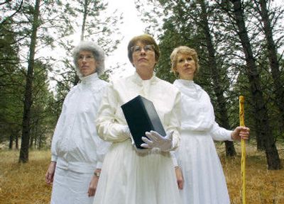 
 From left, Tamara Kittelson-Aldred, Frances Coover and Cate Campbell stand in the forest near Missoula on Jan. 15. Coover is proprietor of Ladies in White, a business in which she and her helpers carry people's ashes into the wild and scatter them. 
 (Associated Press / The Spokesman-Review)