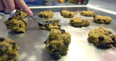 
Nicole Flansburg flattens her batch of Yummy Chocolate Chip Peanut Butter Lentil Cookies at her house in Palouse, Wash., for the National Lentil Festival preliminary lentil cook-off. 
 (Photos by Brian Immel Special to / The Spokesman-Review)