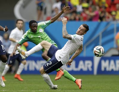 Nigeria's Ahmed Musa, left, and France's Mathieu Debuchy fight for the ball. Musa assisted on a disallowed goal. (Associated Press)