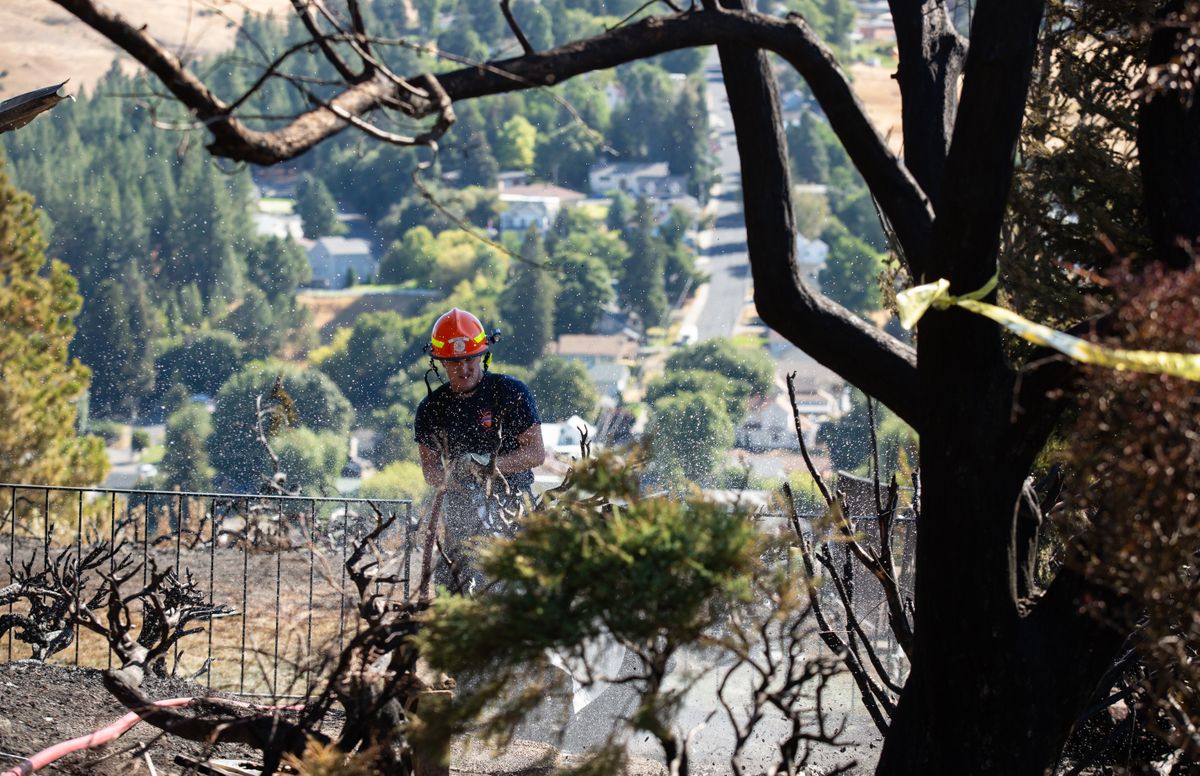 People clean up in Colfax after the fire Sept. 8, 2020 The
