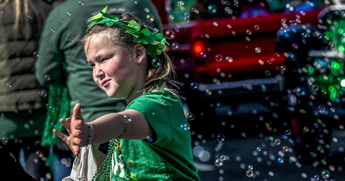 Bubbles surround a parade attendee during the 46th Annual St. Patrick