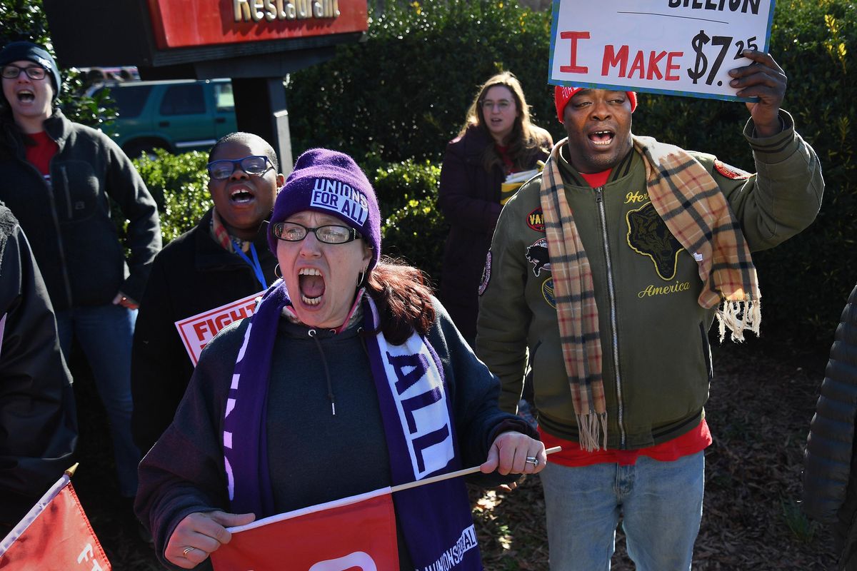 Sara Fearrington (foreground) chants in front of a McDonald’s restaurant during a North Carolina Raise Up protest rally in Raleigh, N.C., on Feb. 8, 2020. She recently became active in the movement. At right is Keenan Harton, who works three jobs to make ends meet. The group is pushing for a raise in the minimum wage to $15 per hour. The federal minimum wage of $7.25 per hour (which North Carolina follows) has not been raised in 10 years. (Michael S. Williamson / Washington Post)