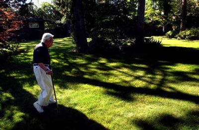 
Ed Tsutakawa strolls through his backyard toward the Japanese gardens throughout his property. 
 (The Spokesman-Review)