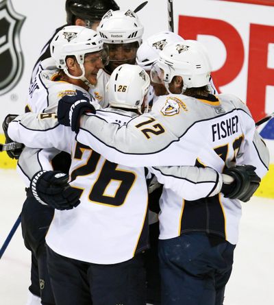 Nashville Predators players celebrate Ryan Suter’s tying goal against the Vancouver Canucks at 18:53 of the third period. (Associated Press)