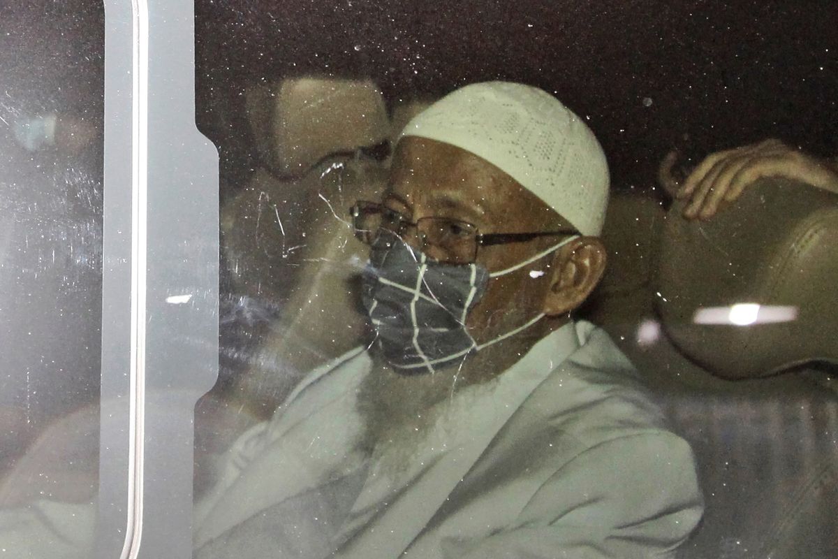 Islamic cleric Abu Bakar Bashir sits inside a van as he leaves upon his release from Gunung Sindur Prison in Bogor, West Java, Indonesia, Friday, Jan. 8, 2021. The convicted firebrand cleric who inspired the Bali bombers and other violent extremists walked free from prison Friday after completing his sentence for funding the training of Islamic militants.  (Aditya Irawan)