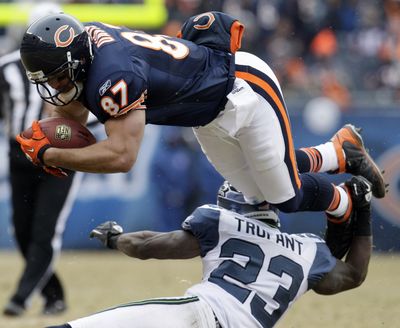 Chicago Bears' Kellen Davis (87) is tackled by the Seattle Seahawks' Marcus Trufant (23) during the second half an NFL divisional playoff football game Sunday, Jan. 16, 2011, in Chicago. Trufant was injured on the play. (Nam Huh / Associated Press)