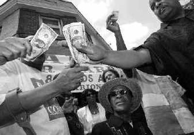 
Marion Barry watches as supporters donate money during the announcement of his campaign for Ward 8 seat on the Washington, D.C., Council on Saturday.
 (Associated Press / The Spokesman-Review)