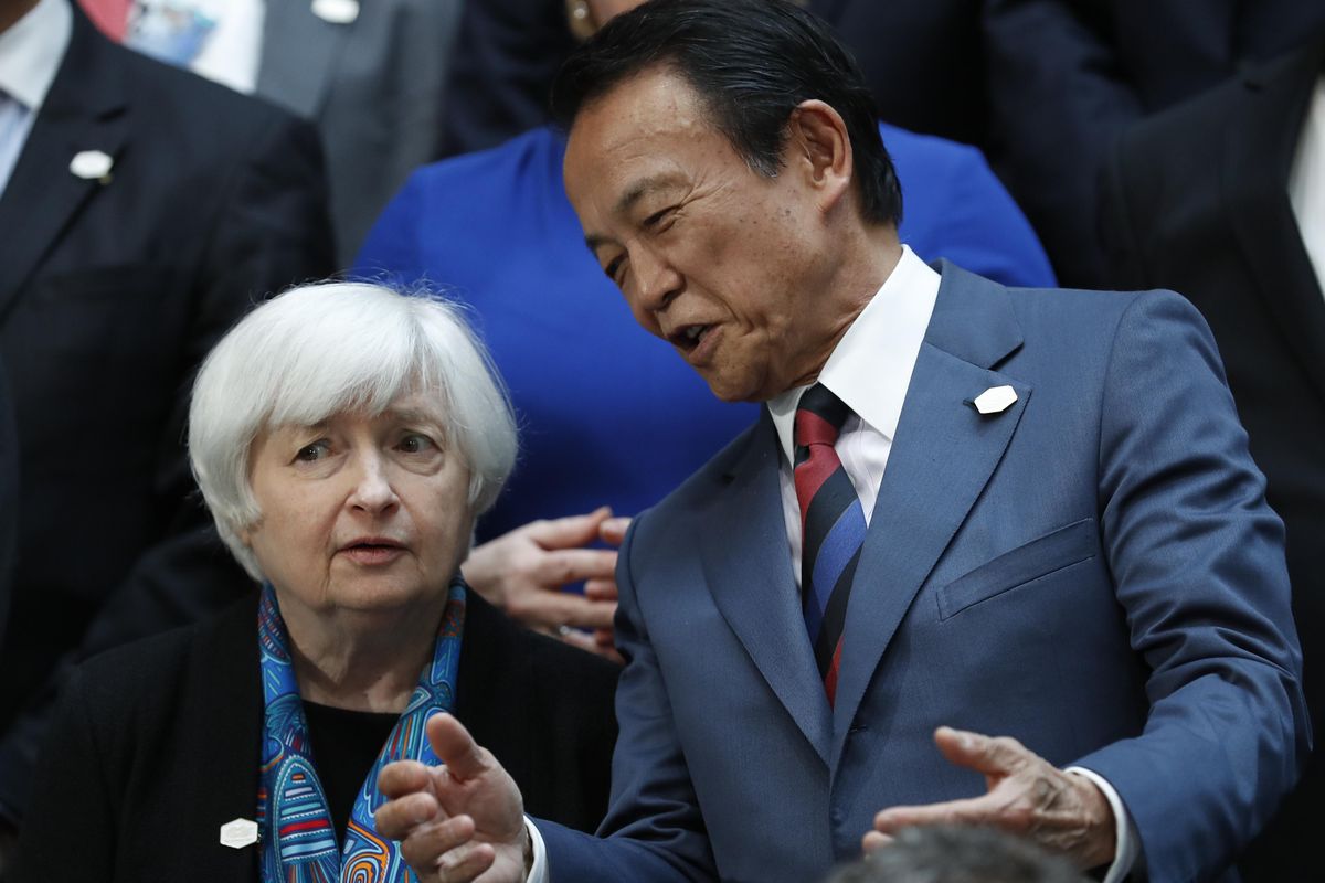 Federal Reserve Chair Janet Yellen talks with Japanese Finance Minister Taro Aso as they gather for the Family Photo during the G20 at the 2017 World Bank Group Spring Meetings in Washington, Friday, April 21, 2017. (Carolyn Kaster / Associated Press)