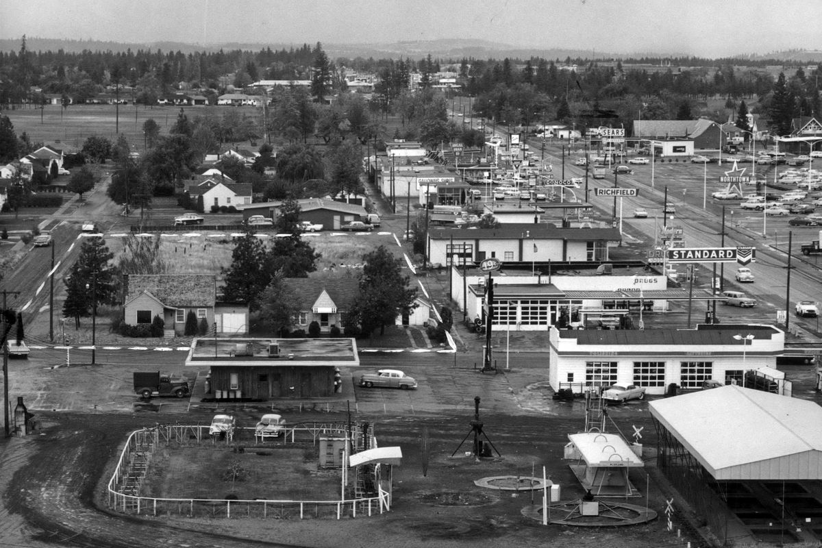 1963: The property in the center left of the photo, marked with a dotted white line, is the location of the Wendle Ford car dealership near the NorthTown shopping center. Wellesley is at the foreground, Atlantic at the left. Owner Chud Wendle would build his car dealership, eventually taking up the entire block. Across the street, NorthTown, which started with an Albertson’s supermarket, a Sears store and a handful of other shops, would grow into a massive retail destination mall, prompting the Wendle family to move their dealership north to the Division Y and turn the northwest corner of Division and Wellesley into a retail development called Northtown Square.  (The Spokesman-Review photo archive)