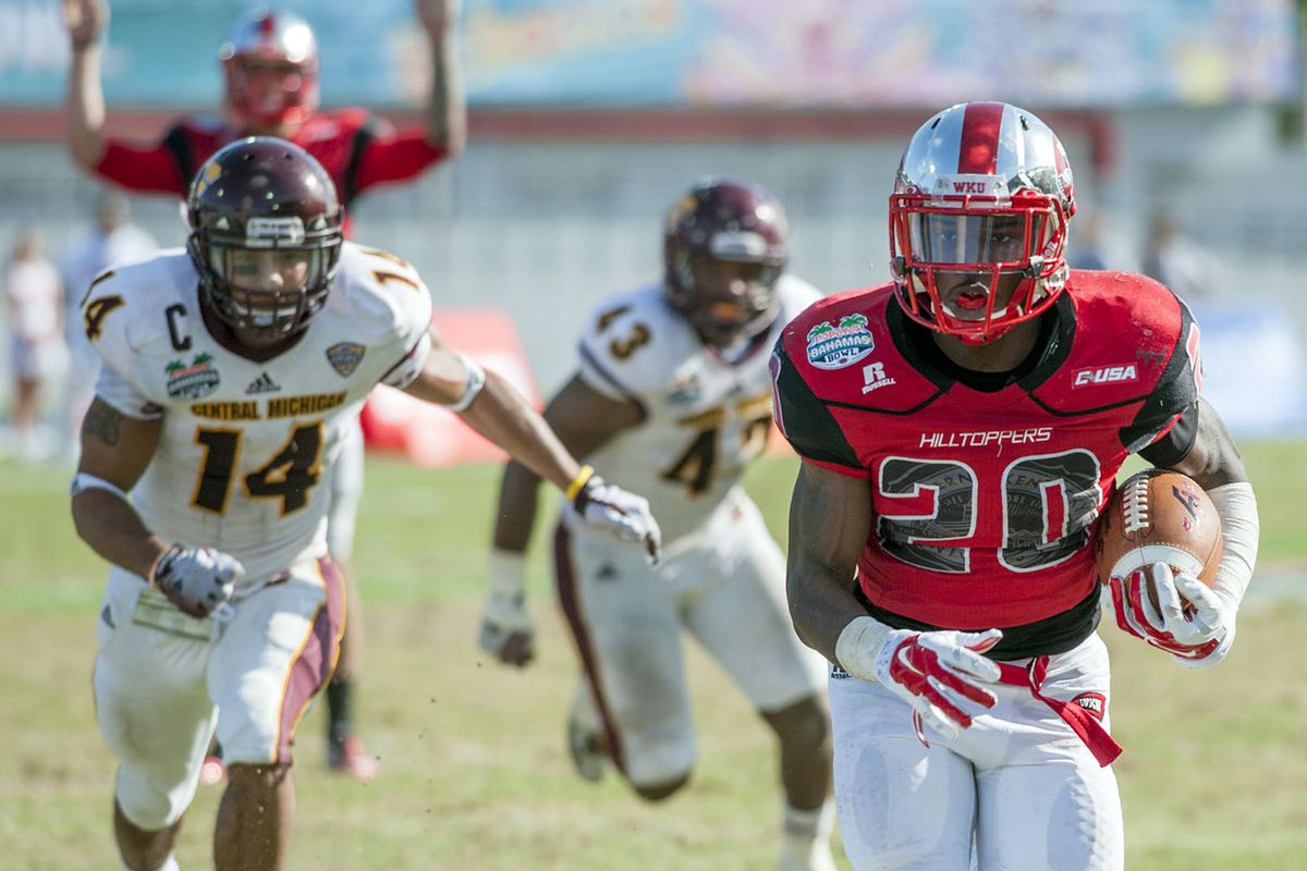 Western Kentucky running back Anthony Wales steams toward a touchdown Wednesday with Central Michigan’s defense in pursuit. (Associated Press)
