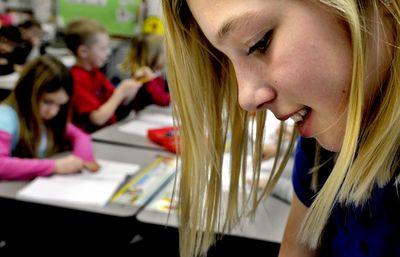 Skyway Elementary fifth grader Danni Payton helped out in the first-grade class Feb. 27 at the school in Coeur d’Alene.  (Kathy Plonka / The Spokesman-Review)