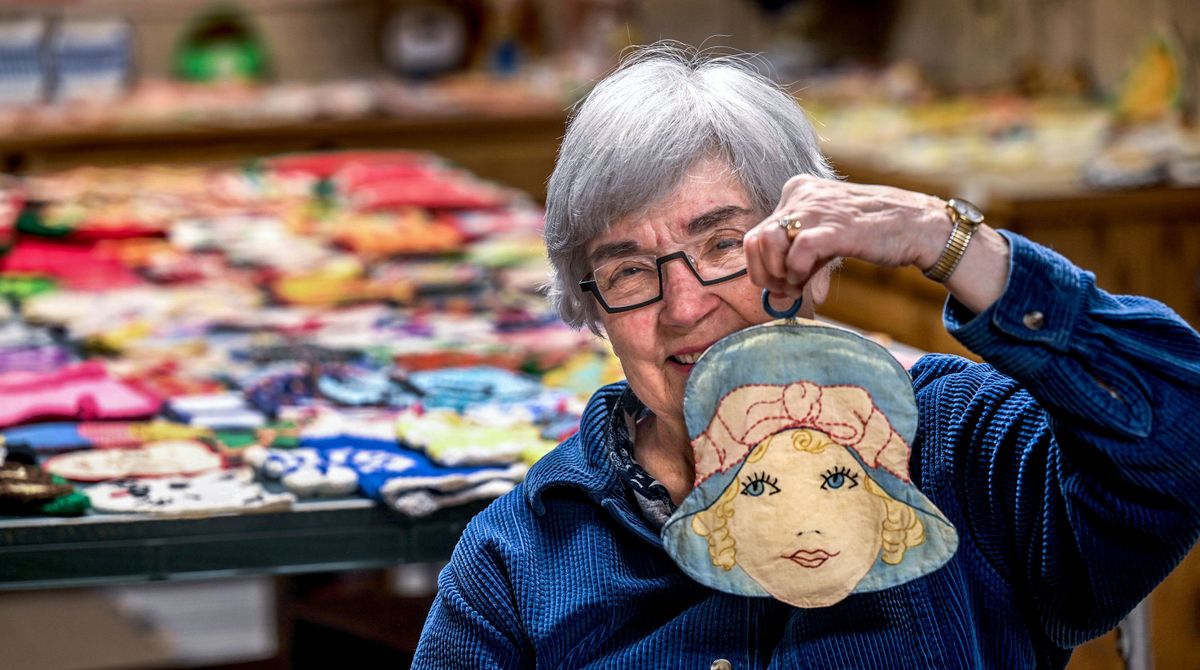 Ginger Wright displays one of her potholders from the 1920s at her home in Coeur d’Alene. Wright has hundreds of potholders, many picked up during travels.  (Kathy Plonka/The Spokesman-Review)